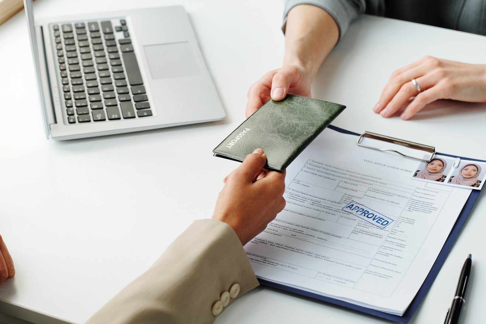 Woman Giving Passport To Consular Officer